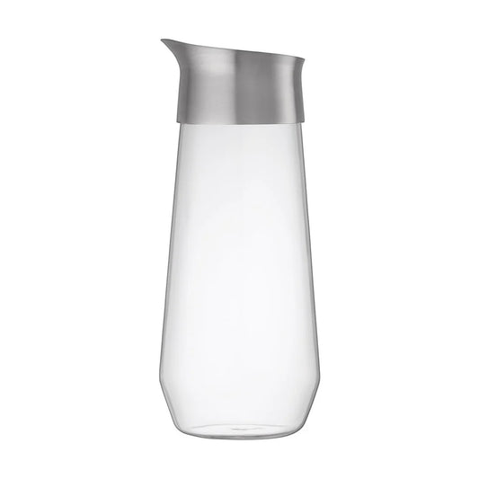 Clear glass carafe with silver lid on a white background