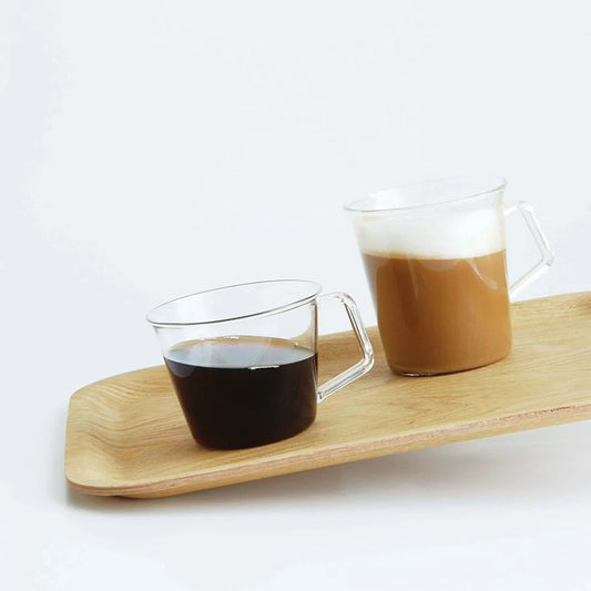 Two glasses of coffee on a wooden tray with a white background